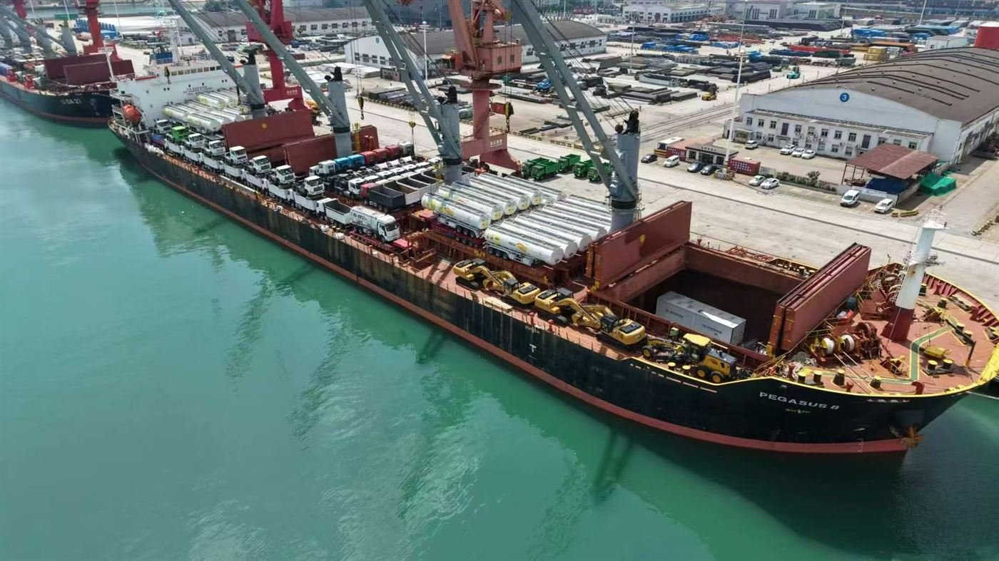 Trucks, semi-trailers and construction machinery loaded on a vessel at port