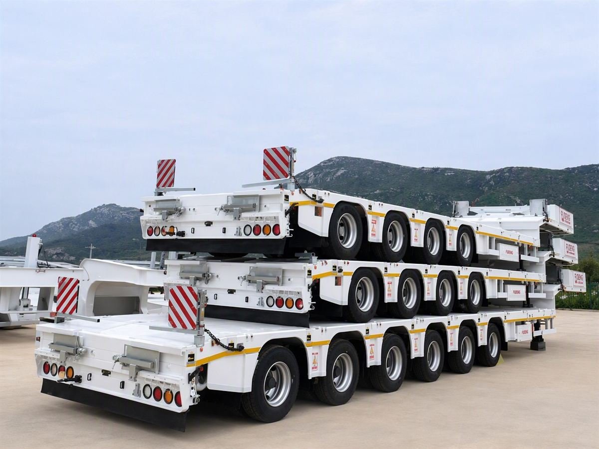 Lowbed semi-trailers stacked for container shipment